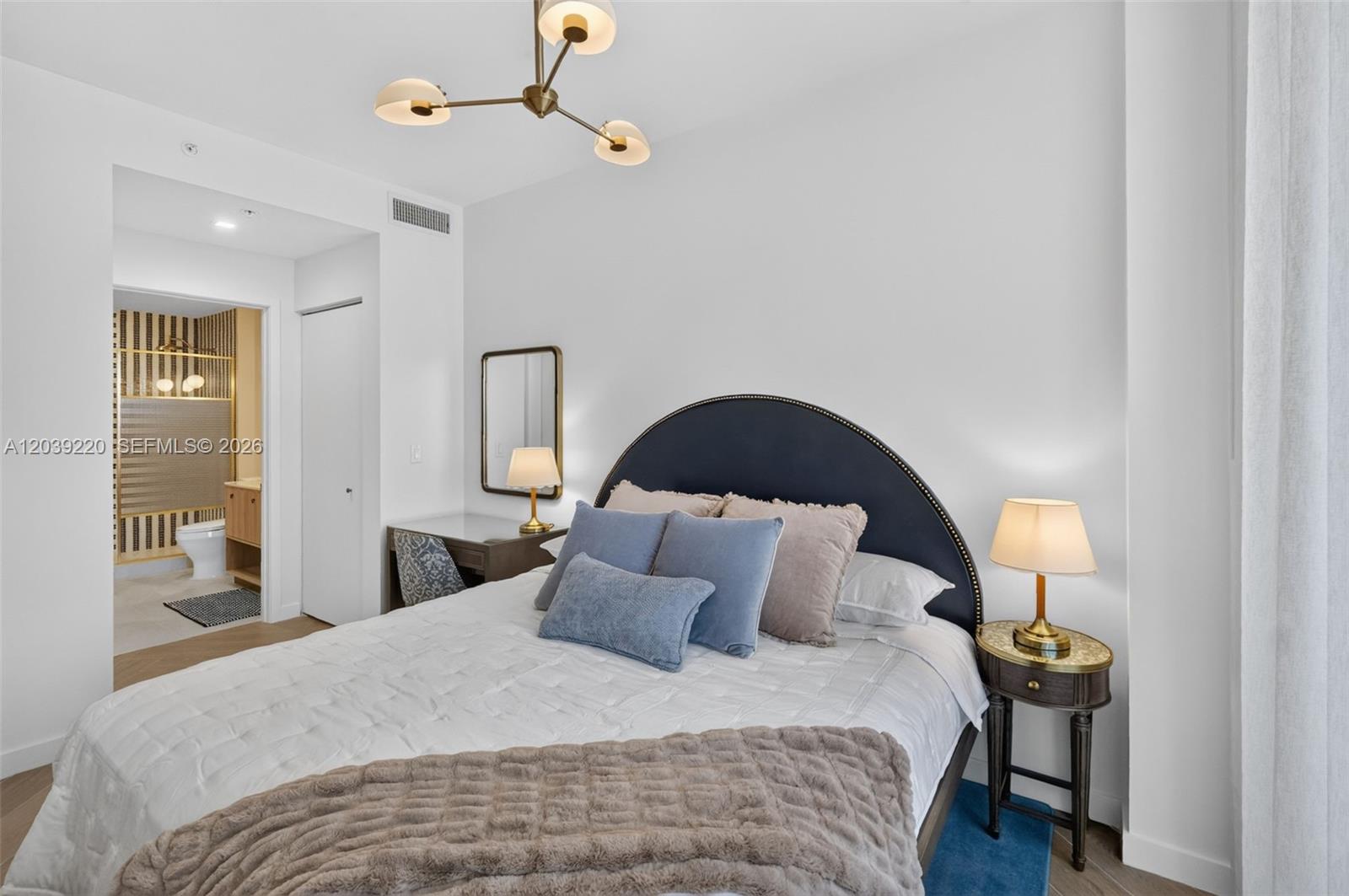 A bedroom features a dark blue arched headboard, a desk, and an attached bathroom — 2700 NW 2ND AVE # 528, Miami FL 33127, MIAMI, FL