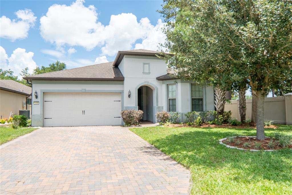 A single-story house with a paved driveway, a two-car garage, and a covered entryway — 1188 PATTERSON TERRACE, LAKE MARY, FL
