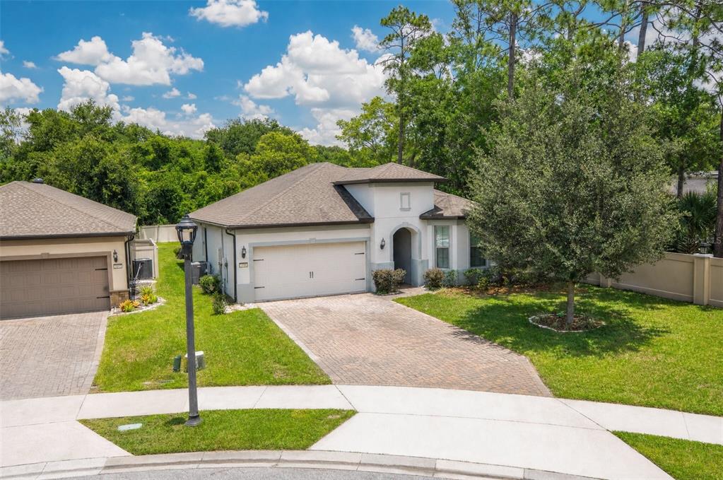 A single-story house with a white stucco facade, a two-car garage, and a paved driveway — 1188 PATTERSON TERRACE, LAKE MARY, FL