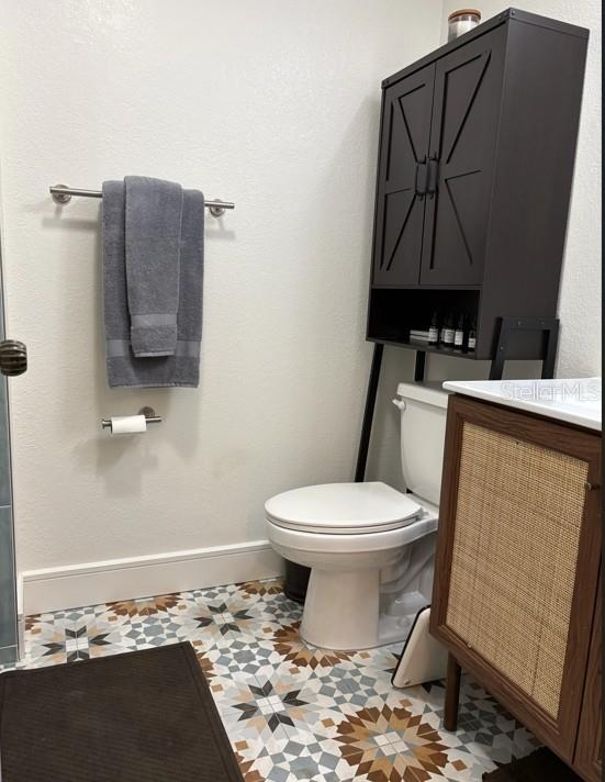 A kitchen features light wood cabinets, a white countertop, a microwave, and a stainless steel refrigerator — 36750 US HIGHWAY 19 N UNIT 6-105, PALM HARBOR, FL