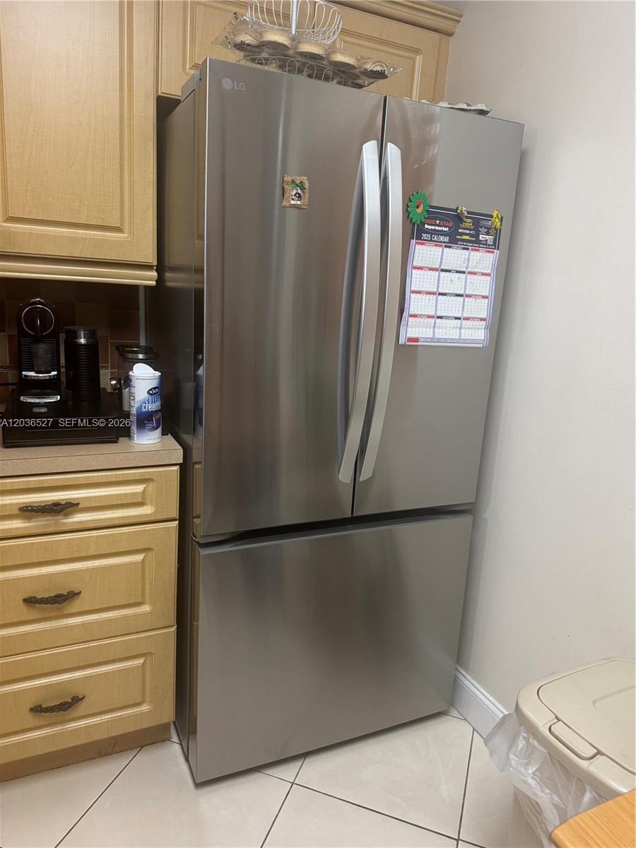 A stainless steel LG refrigerator stands in a kitchen with light wood cabinets — 8625 NW 8th St # 310, Miami FL 33126, MIAMI, FL