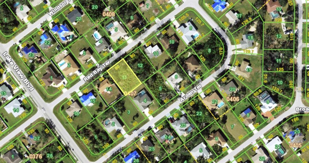 This is an aerial map showing a vacant residential lot highlighted in yellow — 1067 RED BAY TERRACE NW, PORT CHARLOTTE, FL