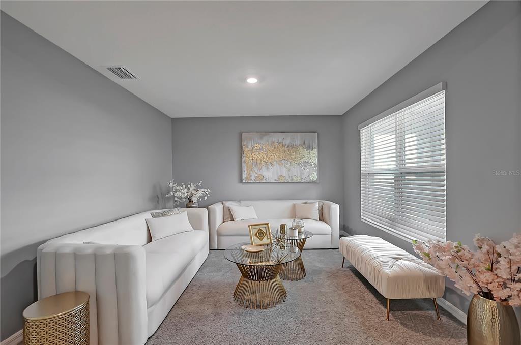 A living room features two white sofas, a glass coffee table, and a white bench — 7737 ROSEWOOD GARDEN LOOP, TAMPA, FL