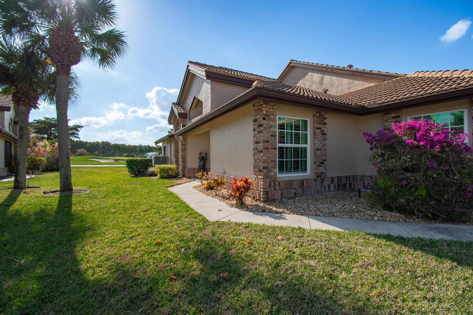 A single-story house with a brick-accented exterior, tile roof, and a view of a golf course — 8213 Cassia Drive, Boynton Beach FL 33472, BOYNTON BEACH, FL