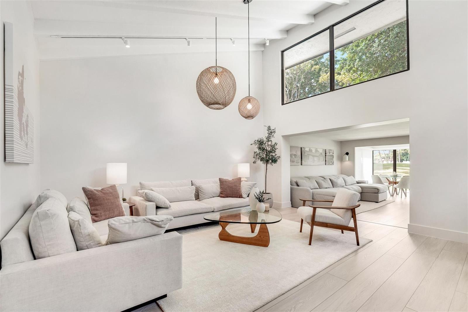 A bright living room features high ceilings, two woven pendant lights, and light-colored furniture — 8569 Casa Del Lago, Boca Raton FL 33433, BOCA RATON, FL
