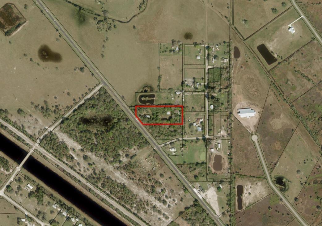 An aerial view shows a rectangular property outlined in red within a rural landscape — 6015 State Road 710, Okeechobee FL 34974, OKEECHOBEE, FL