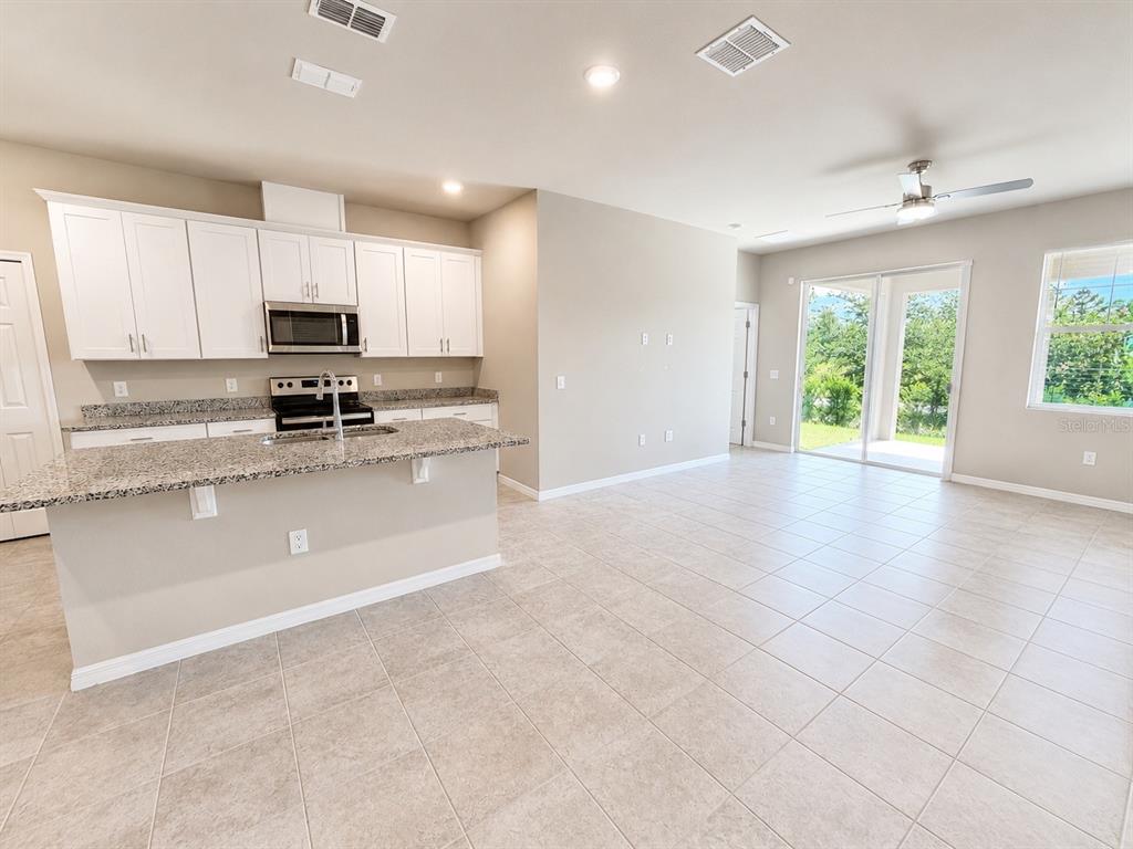 An aerial view of a community clubhouse featuring swimming pools, a playground, and tennis courts — 2269 MYSTIC MAZE LANE, MINNEOLA, FL
