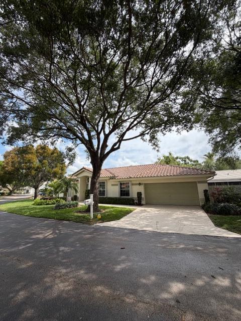 A single-story house with a tile roof and a large tree in the front yard — 3415 Dunes Vista Drive, Pompano Beach FL 33069, POMPANO BEACH, FL