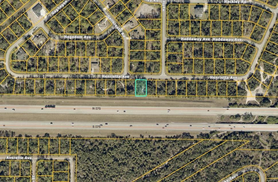 This aerial map shows a highlighted residential lot located adjacent to a major highway — Lot #32 HENRIETTA AVENUE, NORTH PORT, FL