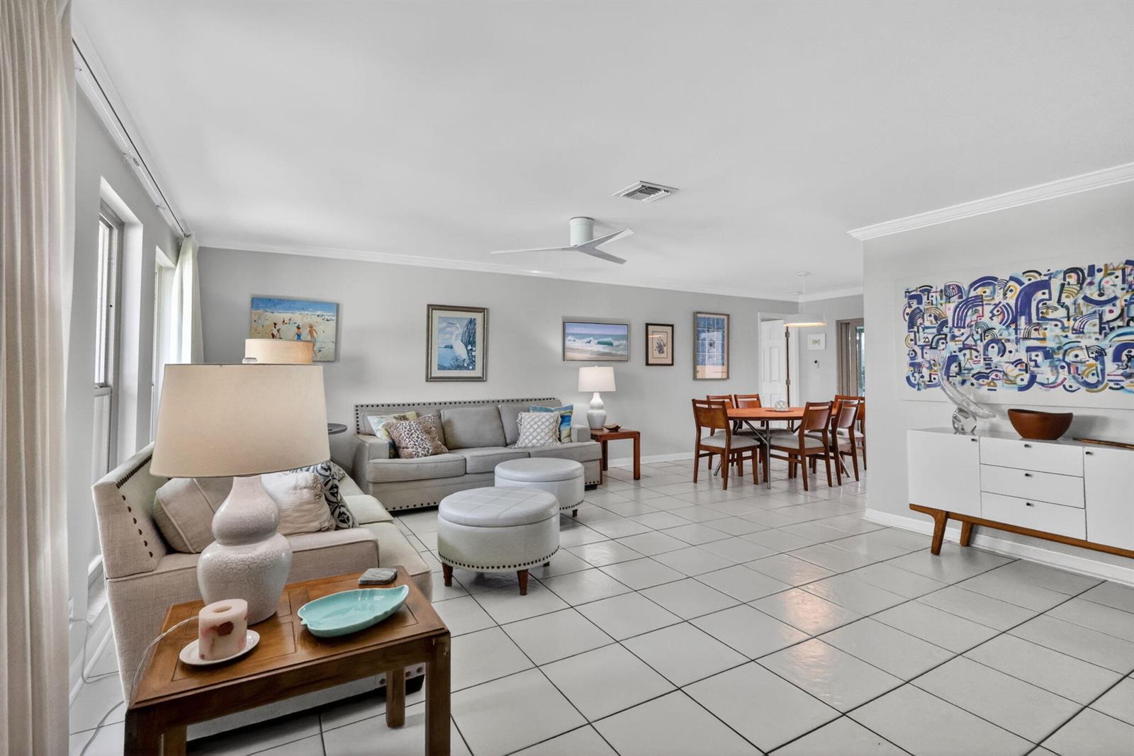 A living and dining area with light gray walls, white tile floors, and neutral furniture — 6372 Sleepy Willow Way, Delray Beach FL 33484, DELRAY BEACH, FL