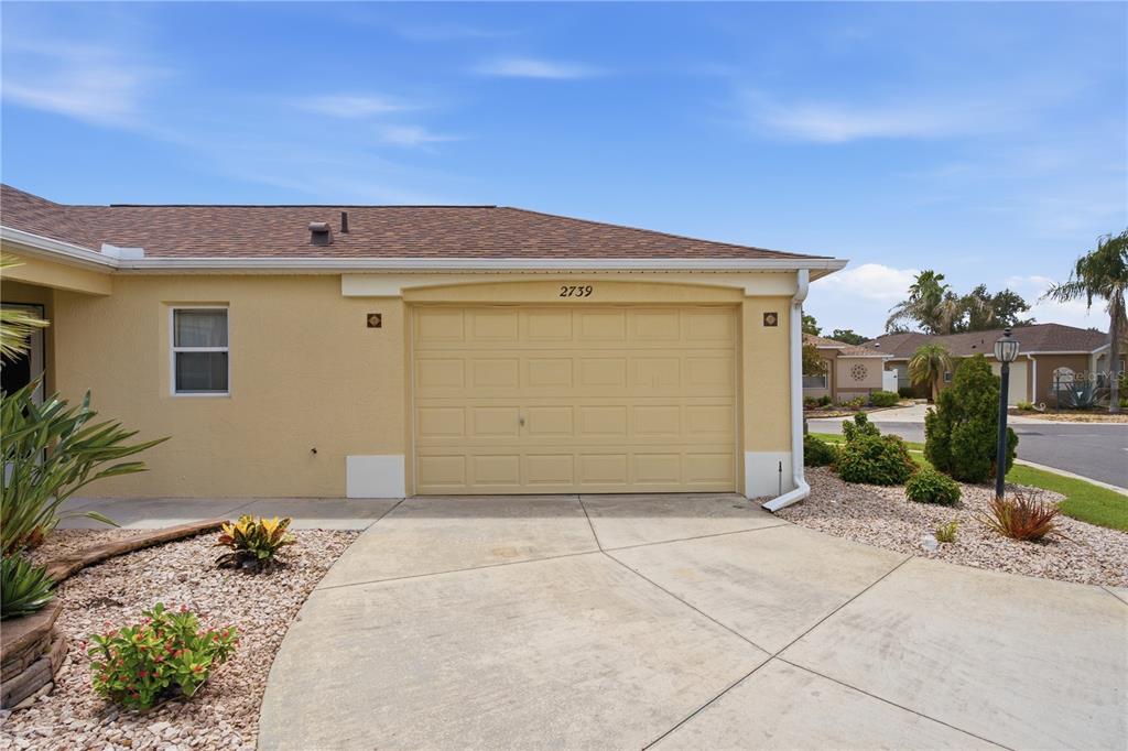 An aerial view of a single-story house with a brown roof and a screened lanai — 2739 ALANDARI LANE, THE VILLAGES, FL