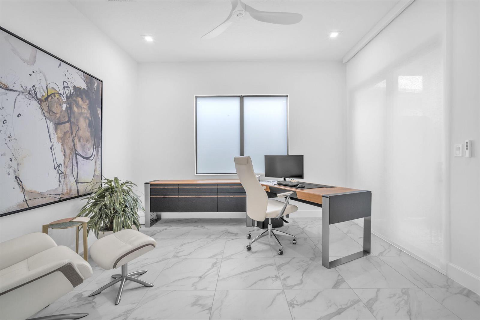 A modern home office features a desk, a white chair, and marble tile flooring — 9651 Spruce Woods Drive, Boynton Beach FL 33473, BOYNTON BEACH, FL