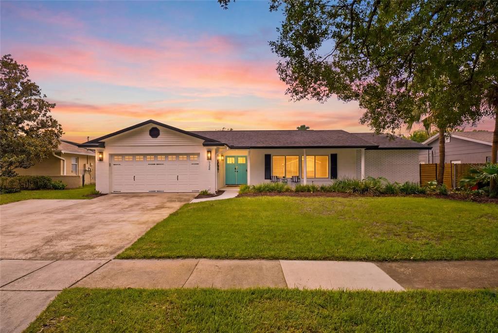 A backyard features a swimming pool, a wooden pergola, and a paved patio area — 722 S RANGER BOULEVARD, WINTER PARK, FL