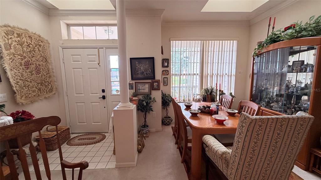 A dining room features a wooden table, chairs, a display cabinet, and an entryway door — 3671 E ARBOR LAKES DRIVE, HERNANDO, FL