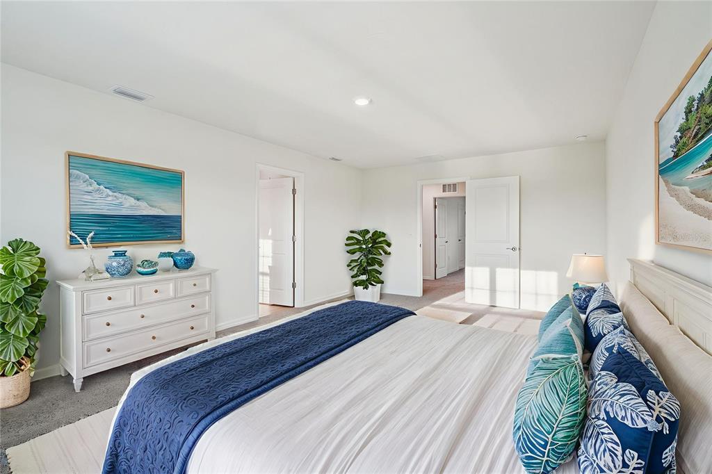 A bedroom features a white dresser, a bed with blue bedding, and two framed pictures — 8907 SW 46TH AVENUE, OCALA, FL