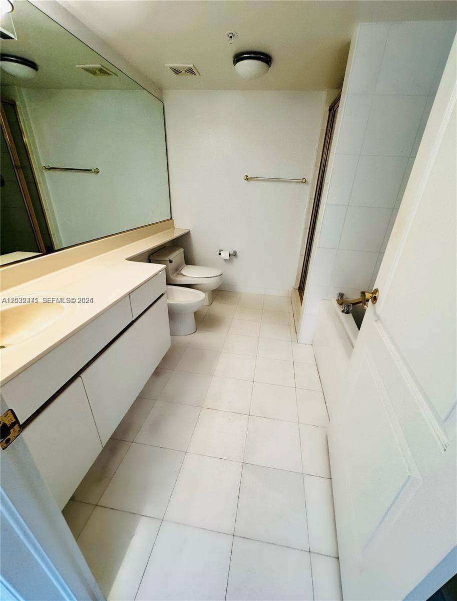 A bathroom features a long vanity, a toilet, a bidet, and a tiled shower area — 1900 Sunset Harbour Dr # 815, Miami Beach FL 33139, MIAMI BEACH, FL