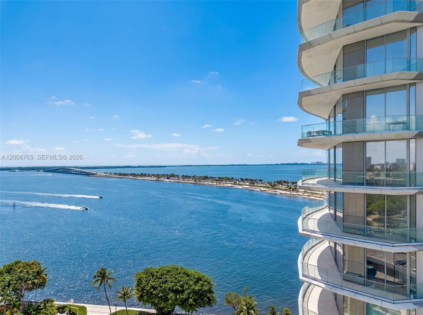 An exterior view of a high-rise building balcony overlooking a bay and a bridge — 175 SE 25th Rd # 604, Miami FL 33129, MIAMI, FL