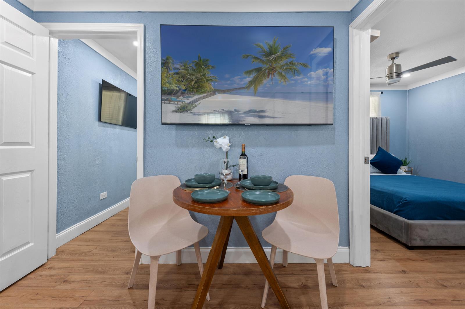 A small dining area with a round wooden table sits between two doorways — 420 Avenida Alegre # 3, West Palm Beach FL 33405, WEST PALM BEACH, FL