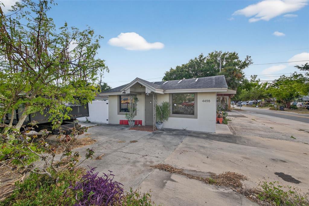 A single-story building with a concrete driveway and a small covered entryway — 4498 49TH STREET N, ST PETERSBURG, FL
