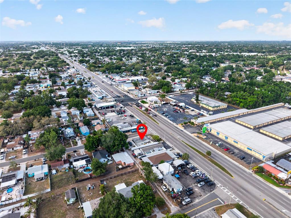 An aerial view shows a commercial property marked with a red pin along a road — 4498 49TH STREET N, ST PETERSBURG, FL