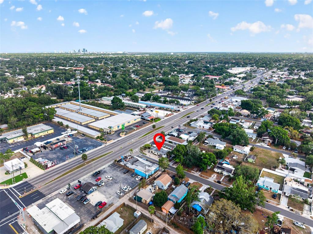 This aerial view shows a commercial building marked with a red pin near a road — 4498 49TH STREET N, ST PETERSBURG, FL