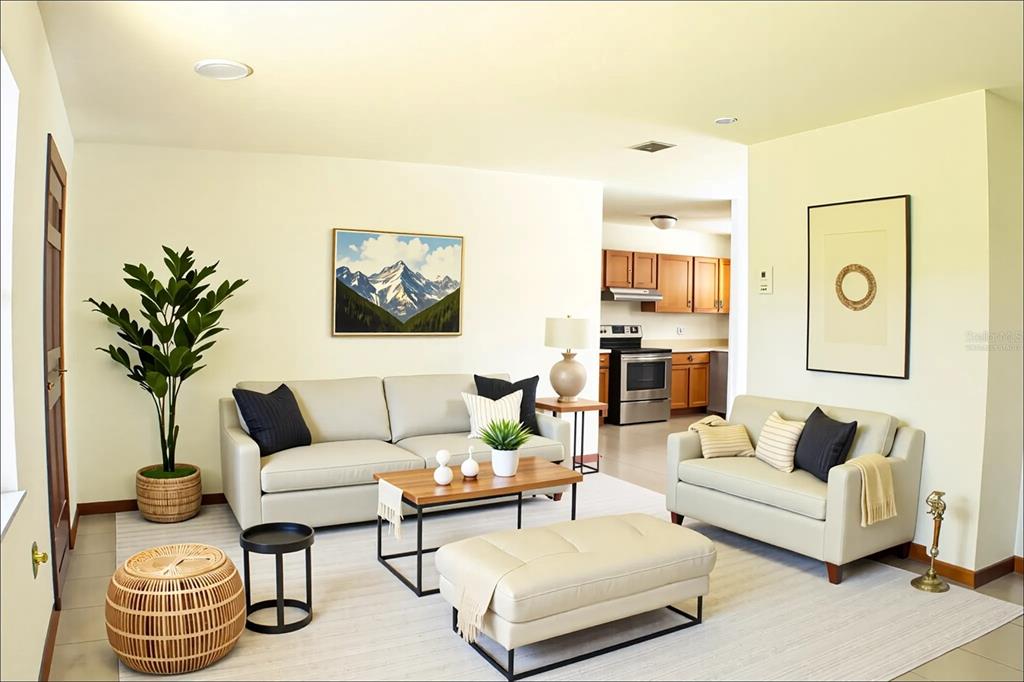 A living room with light-colored sofas, a wooden coffee table, and an open kitchen beyond — 111 HIGHLAND STREET, ORANGE CITY, FL