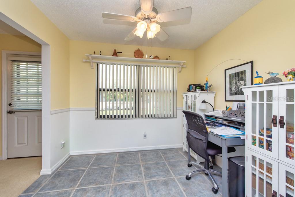 A home office with tile flooring, a desk, a ceiling fan, and a window with blinds — 1605 LELAND DRIVE, SUN CITY CENTER, FL