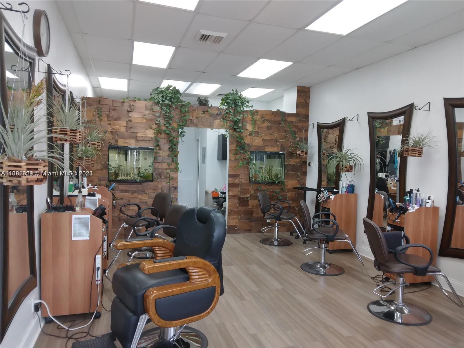 A hair salon features multiple styling stations with mirrors, leather chairs, and a wood-paneled wall — 1801 S Ocean Dr, Hallandale Beach FL 33009, HALLANDALE BEACH, FL