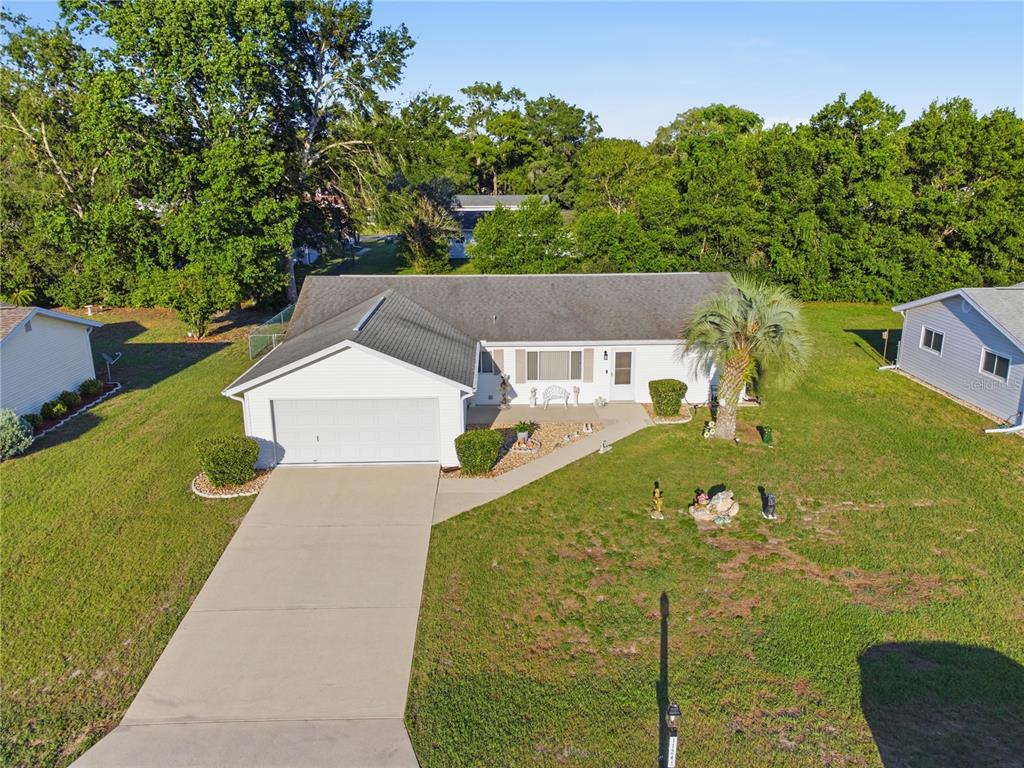 An aerial view shows a single-story house with a white exterior, attached garage, and lawn — 11241 SW 77TH COURT, OCALA, FL