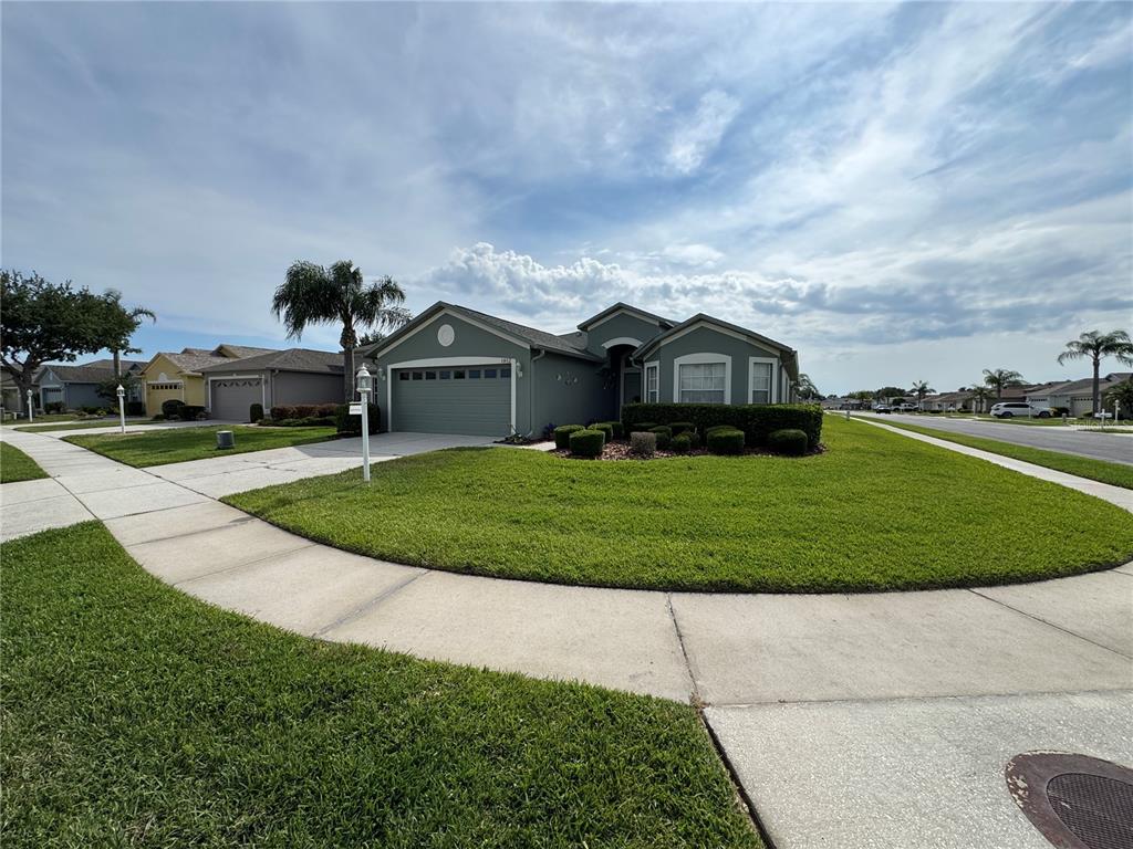This is a floor plan for a three-bedroom, two-bathroom home with a two-car garage — 1852 ARBOR KNOLL LOOP, TRINITY, FL