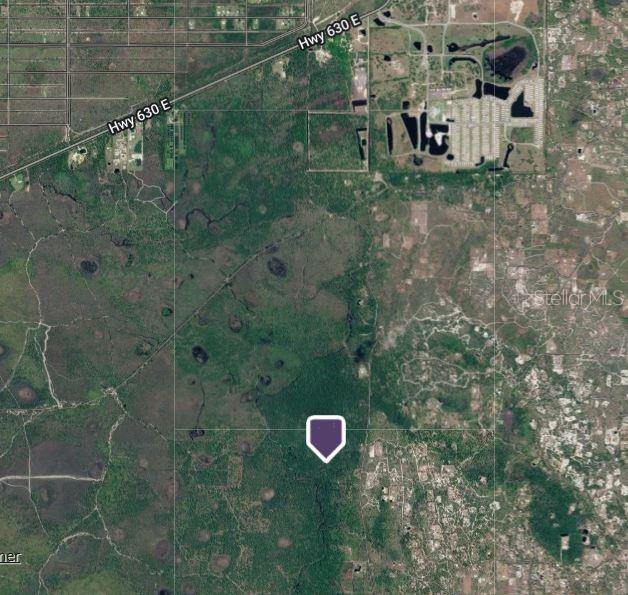 This is an aerial map view showing a plot of land marked with a purple icon — HWY 60, FROSTPROOF, FL