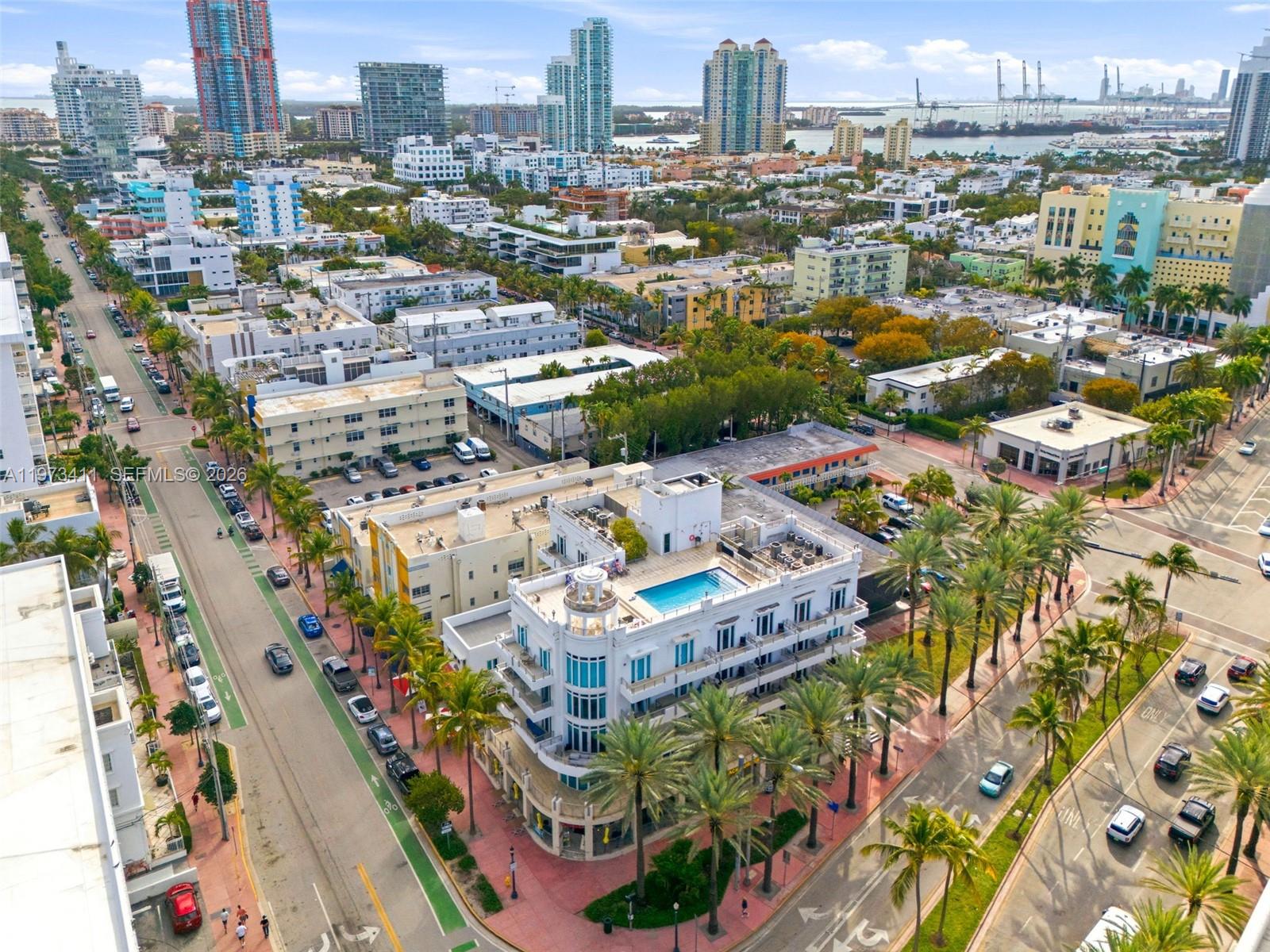 An aerial view shows a white multi-story building with a rooftop pool in Miami — 448 Ocean Dr # 303, Miami Beach FL 33139, MIAMI BEACH, FL