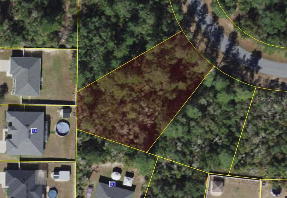 This aerial view shows a vacant, wooded residential lot outlined in yellow — SW 31ST TERRACE ROAD, OCALA, FL
