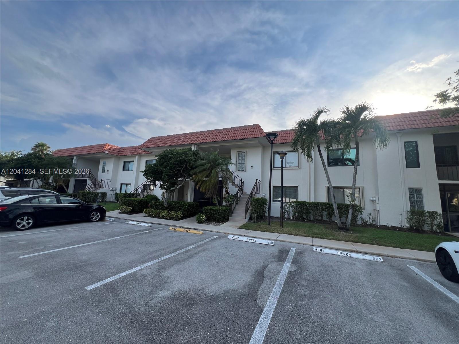 A two-story apartment building with a red tile roof and a paved parking lot — 379 Lakeview Dr # 205, Weston FL 33326, WESTON, FL