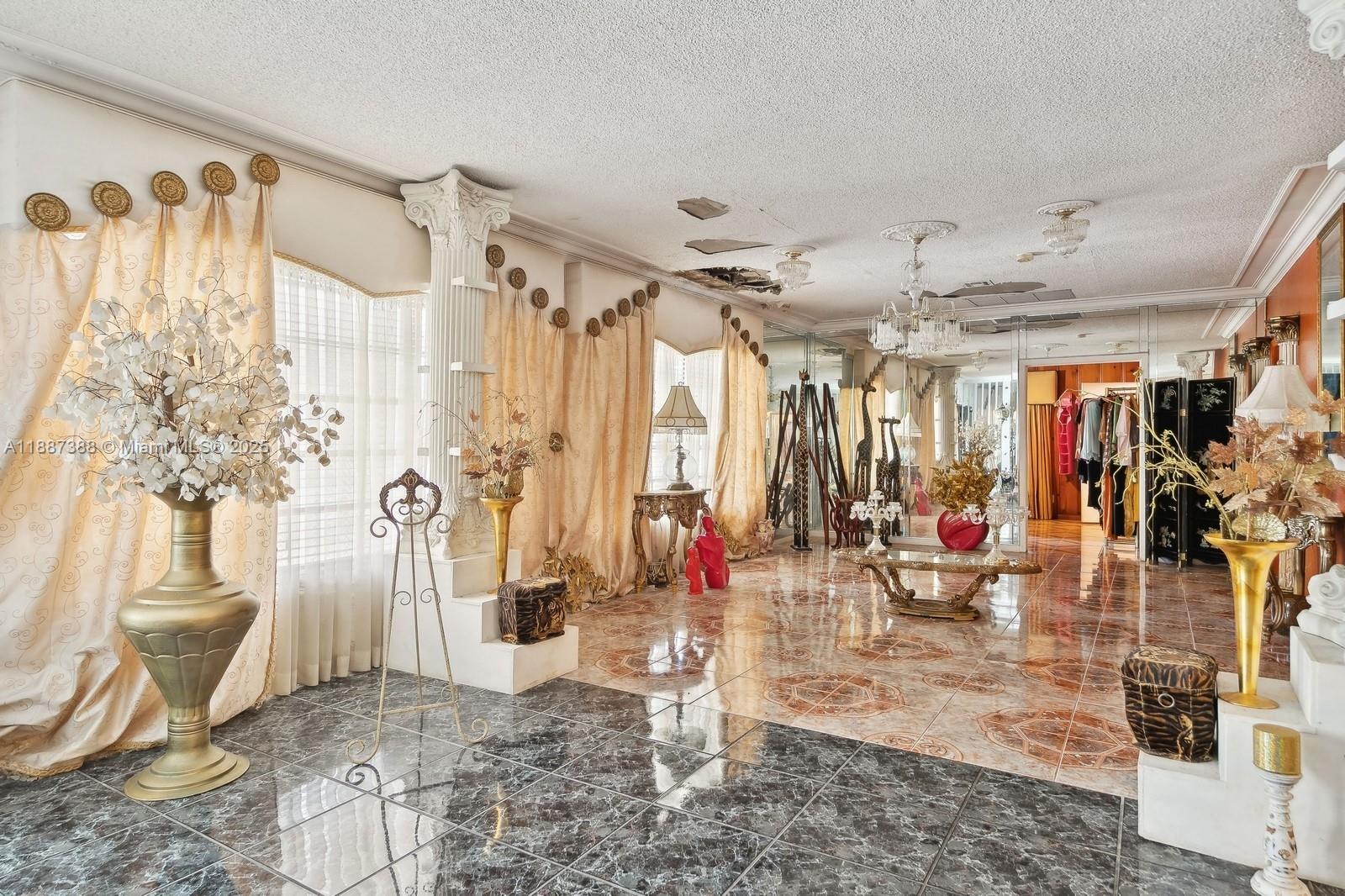 A living room features marble tile flooring, ornate gold curtains, decorative columns, and ceiling damage — 469 NW 69th St, Miami FL 33150, MIAMI, FL
