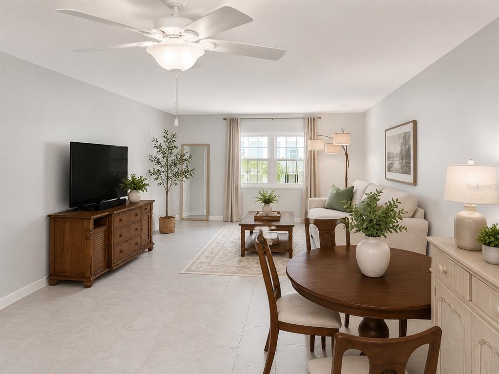 A living room and dining area feature light tile floors, neutral walls, and wooden furniture — 1706 BELLEAIR FOREST DRIVE UNIT 244, BELLEAIR, FL