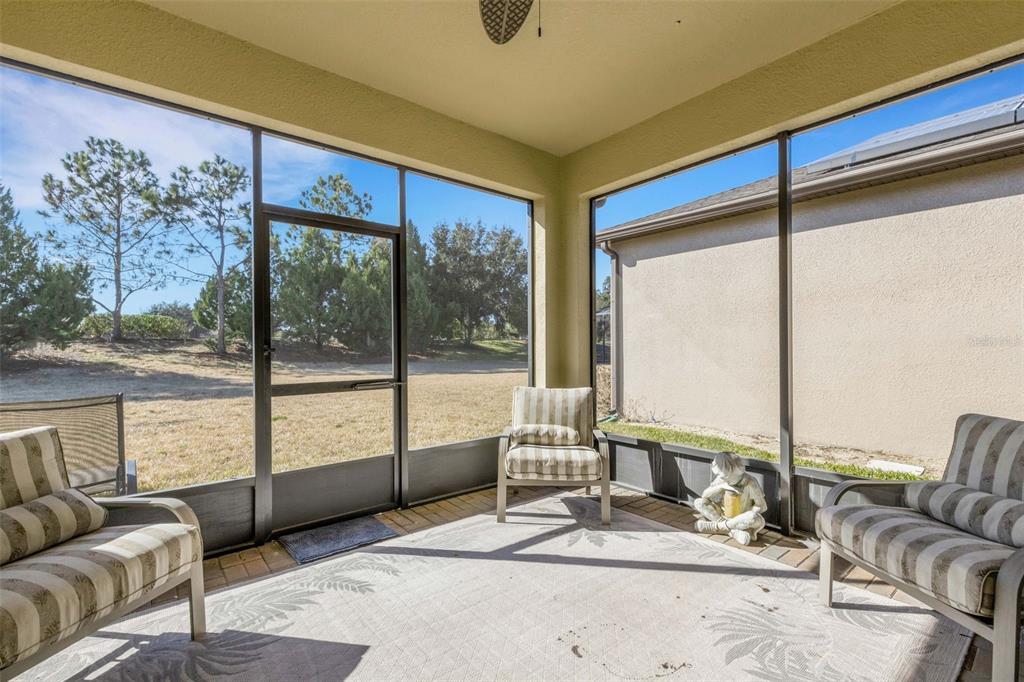 A single-story house with a beige stucco exterior, a paved driveway, and a palm tree — 329 ALICANTE COURT, DAVENPORT, FL