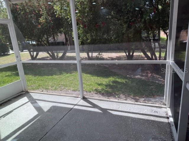 A screened-in concrete patio overlooks a grassy yard with trees — 302 MAYBECK COURT, SANFORD, FL
