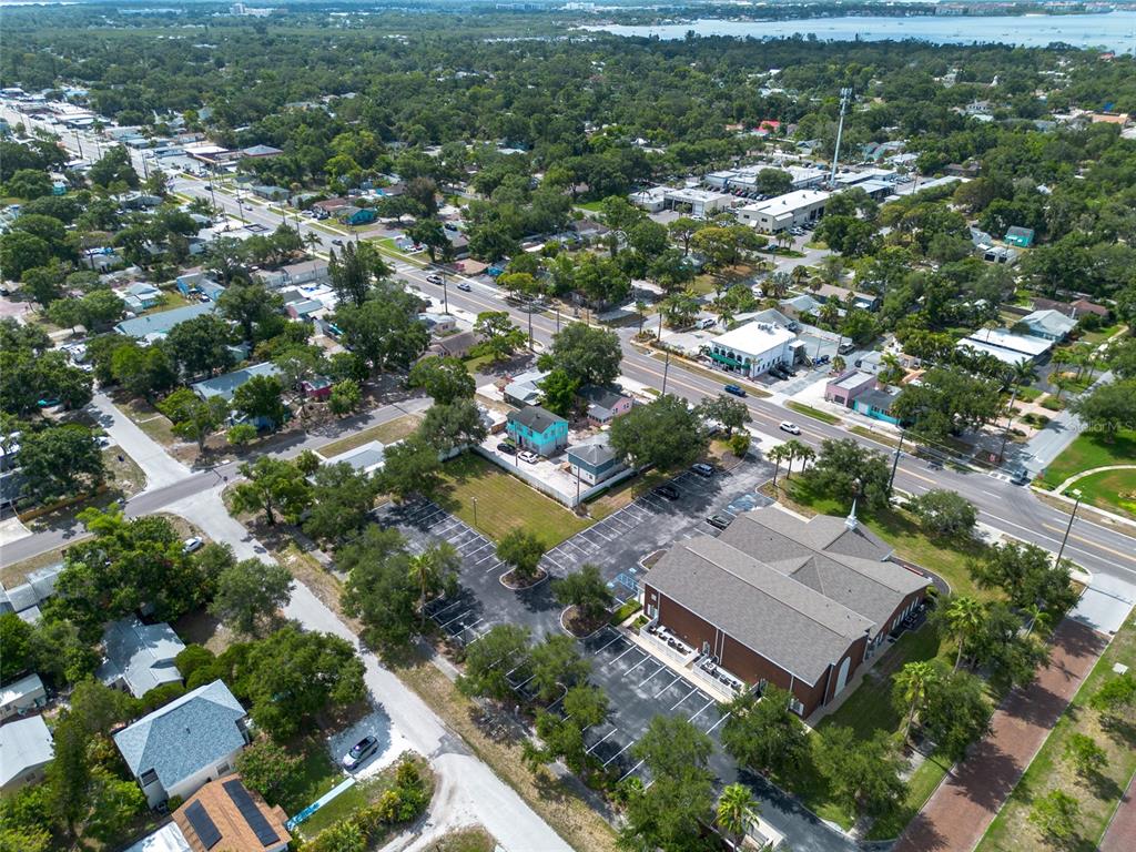 An aerial view shows a church with a parking lot and surrounding residential neighborhood — 1714 55TH STREET S, GULFPORT, FL