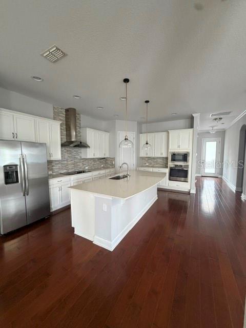 A modern kitchen features white cabinetry, a large center island, and dark hardwood flooring — 8001 NEMOURS PARKWAY, ORLANDO, FL