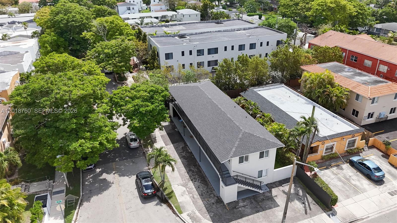 An aerial view shows a two-story apartment building with a gray roof and parking spaces — 2190 SW 14th Ter, Miami FL 33145, MIAMI, FL
