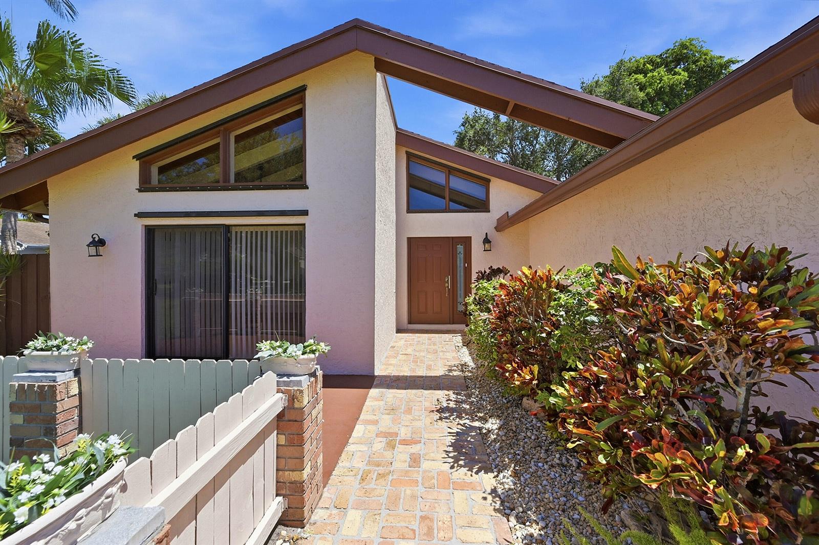A brick walkway leads to the front door of a house with angled rooflines — 21540 Kapok Circle, Boca Raton FL 33433, BOCA RATON, FL
