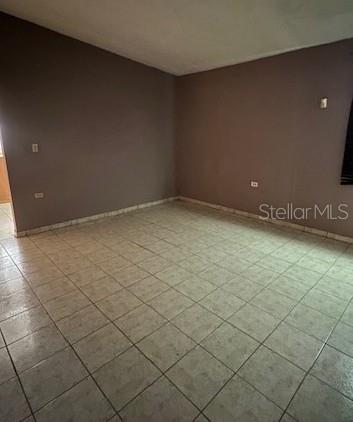 An empty room features light-colored tile flooring and plain, light-brown walls — Carr. 635 Lote 1 BO. AIBONITO, HATILLO, PR