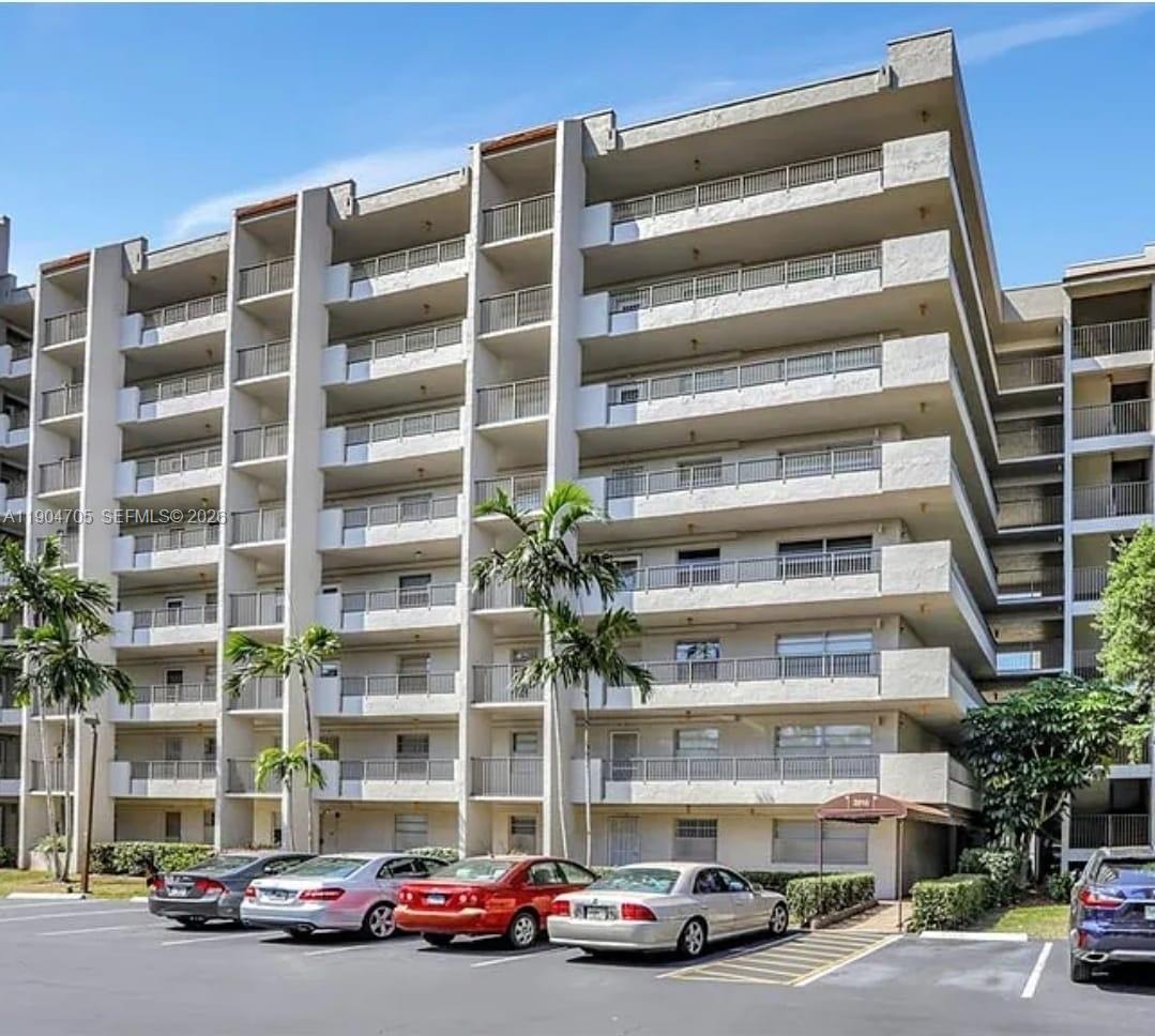 A multi-story residential apartment building with balconies and a parking lot in front — 3910 Inverrary Blvd # B, Lauderhill FL 33319, LAUDERHILL, FL