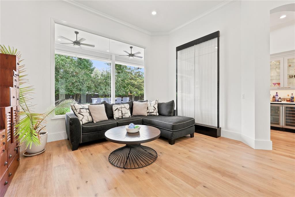 A living room features a dark sectional sofa, a round coffee table, and a water feature — 5117 NW 55TH STREET, GAINESVILLE, FL