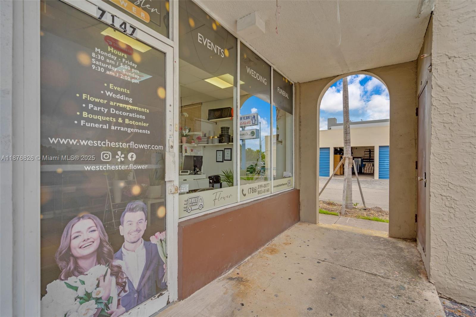 The exterior entrance of a flower shop features glass storefront windows and an arched walkway — 7147 SW 8th St, Miami FL 33144, MIAMI, FL
