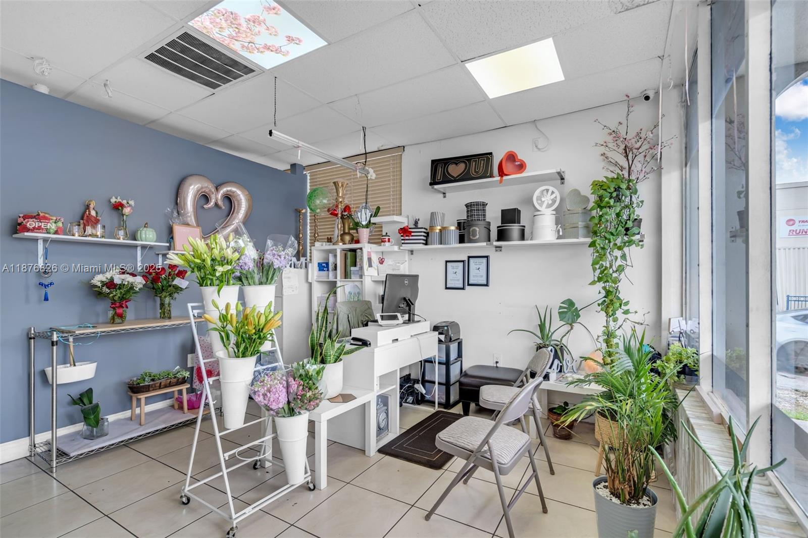 A small flower shop interior features floral displays, a desk, and various potted plants — 7147 SW 8th St, Miami FL 33144, MIAMI, FL