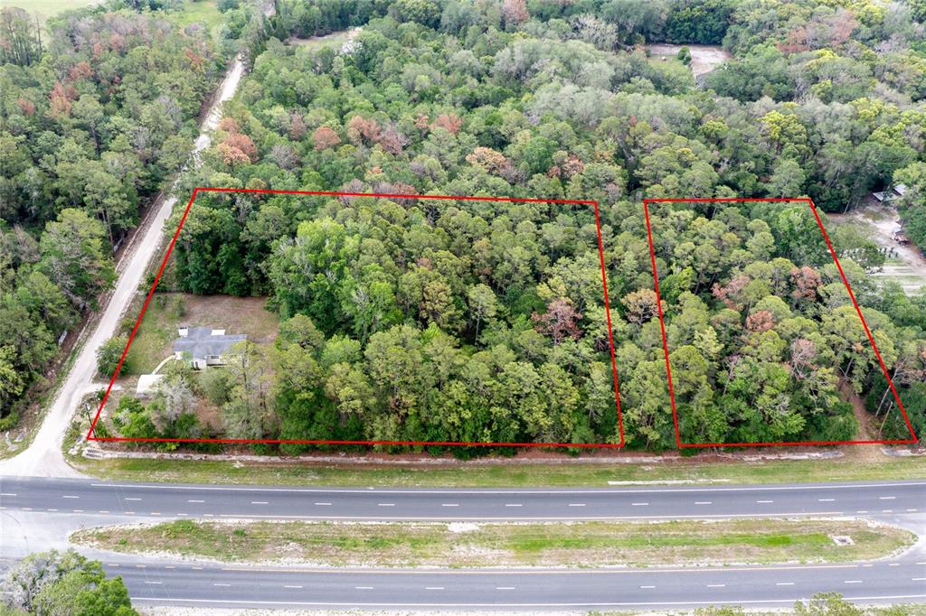 An aerial view shows two adjacent wooded lots outlined in red next to a road — 16913 NE 77TH LANE, HAWTHORNE, FL