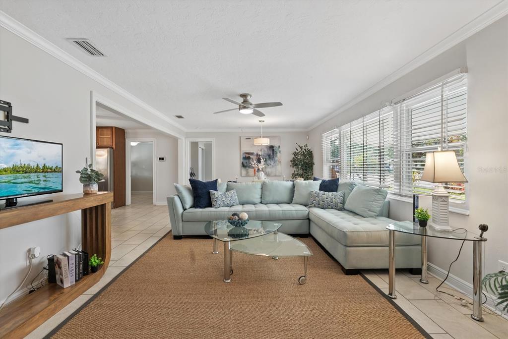 A living room features a light blue sectional sofa, a glass coffee table, and tile flooring — 361 SCOTT AVENUE, SARASOTA, FL