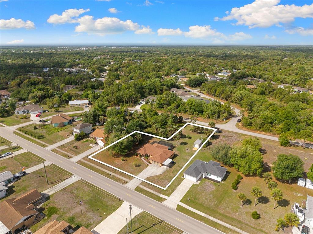 An aerial view shows a single-story house with a brown roof on a large lot — 4607 ATWATER DRIVE, NORTH PORT, FL